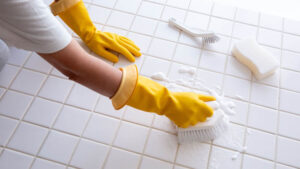 woman cleaning bathroom tiles